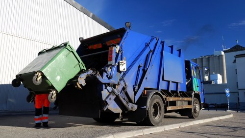 Technicians safely disposing of electronic waste during office clearance