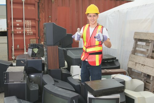 Waste removal team preparing to load a van